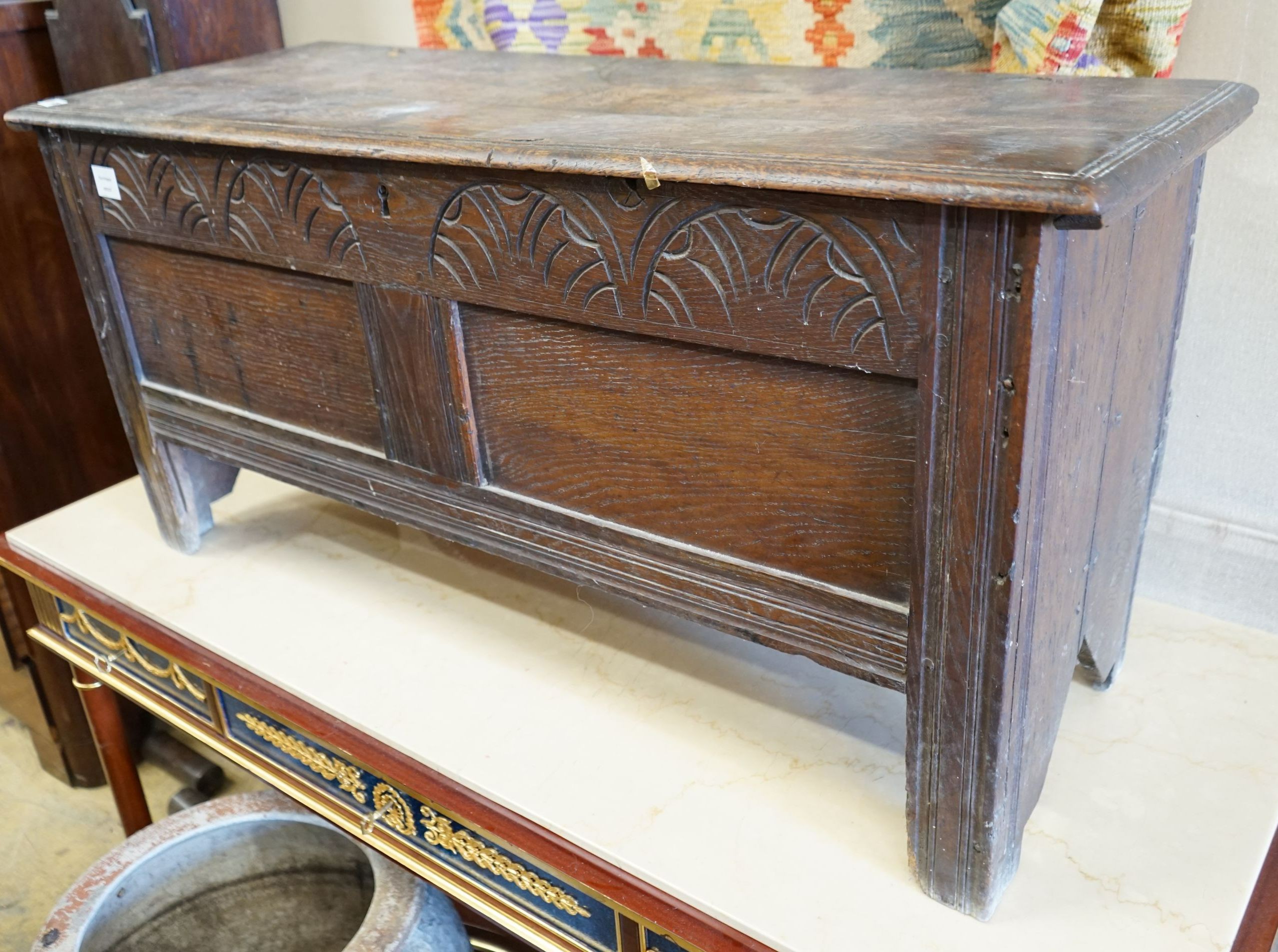 A 17th century and later carved oak six plank coffer, length 117cm, depth 43cm, height 56cm